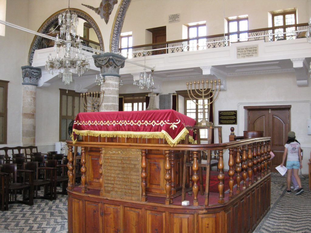 Tevah of the Rhodes synagogue, located in the middle of the house with menoroth surrounding it