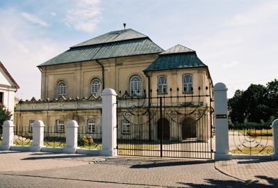 Outside view of the synagogue of Wlodawa and its menorot at the gate