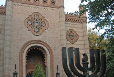 Outside view of the synagogue of Bucharest with a menorah in front