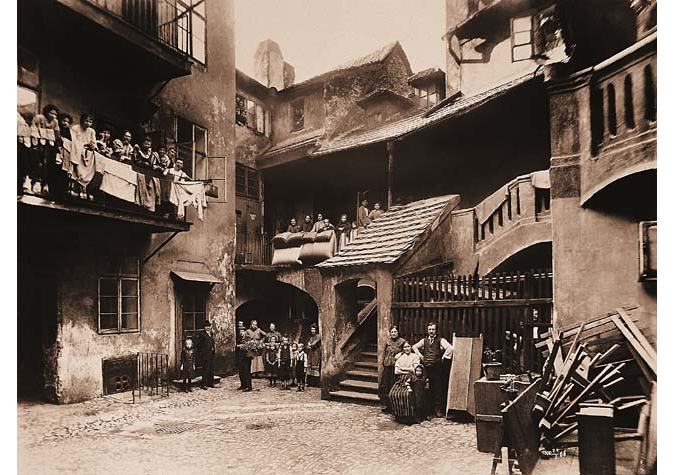 Families standing outside apartments of the Prague ghetto